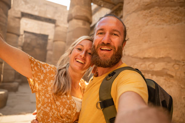 istock Happy couple take selfie inside Karnak Temple in Luxor 1308576461
