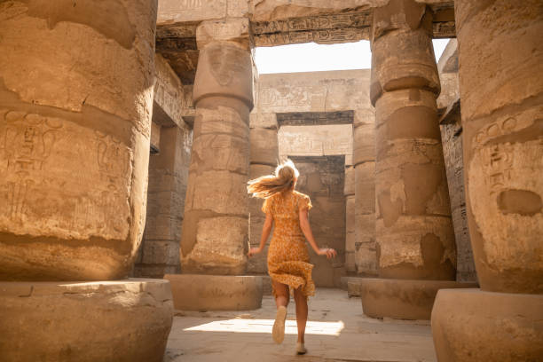 istock Woman runs inside ancient temple in Egypt, sunrise 1308576545