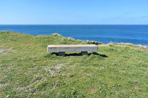 Camariñas, A Coruña Province, Costa da Morte, Galicia, Spain, Europe. Stone bench and viewpoint on a cliff in famous Camiño dos Faros or Way of Lighthouses.