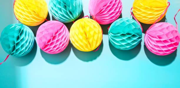 istock Garlands for the carnival on a blue background. Bright festive decor. Poster or postcard. Copy space. High quality photo in hard light 1308577632