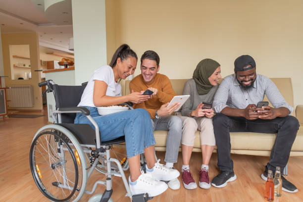 istock Enthusiastic Multi-Ethnic Friends are Hanging Out in the Living Room While Browsing the Internet Content. 1308577709