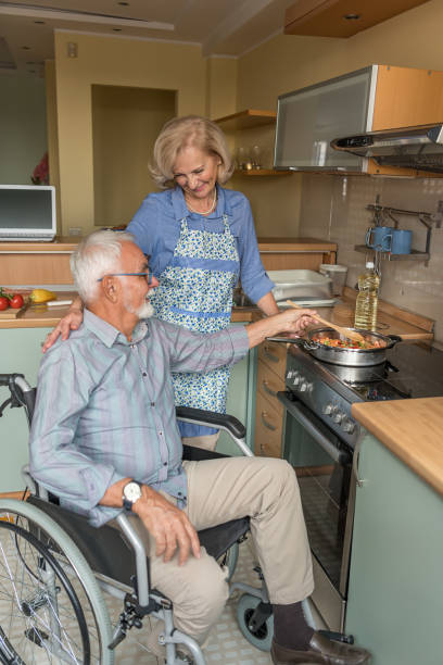 istock Older Couple is Enjoying at Home while Preparing a Delicious Meal. 1308580261