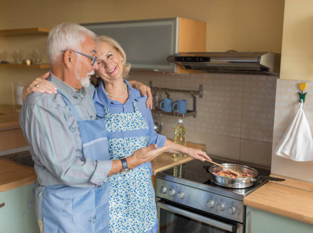istock Cheerful Elderly Spouses Enjoy Free Time at Home and Cooking a Lunch. 1308580356