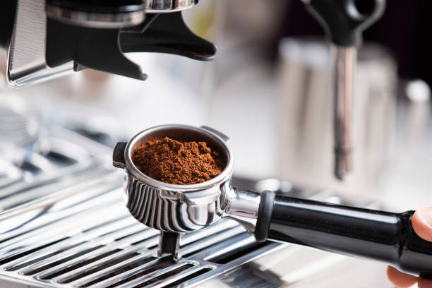 istock Coffee beans in a portafilter by the coffee grinder 1308581838