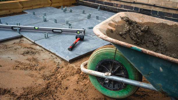 istock Patio being laid with tools and wheelbarrow full of concrete 1308583736