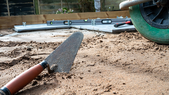 Trowel laying on the ground ready to lay a patio