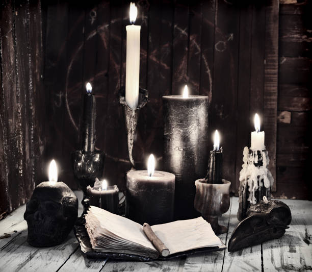 istock Grunge still life with burning candles and open diary book on witch table. 1308586470