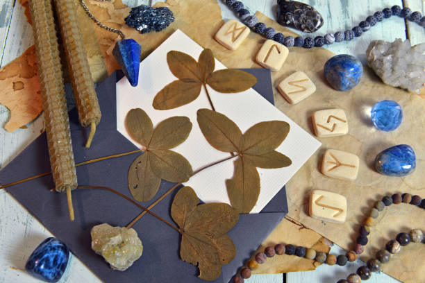 istock Still life with four leaf clover, runes, candles and crystals on witch table. 1308587188
