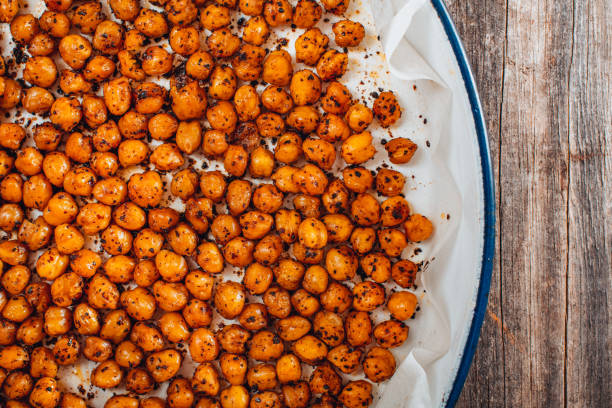 Flat Lay Roasted Spicy Snack Chickpeas in Tray Flat Lay Roasted Spicy Snack Chickpeas in Tray chickpea stock pictures, royalty-free photos & images