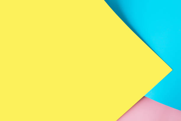 istock Multicolored sheets of paper placed geometrically randomly. Yellow, pink, blue 1308587551