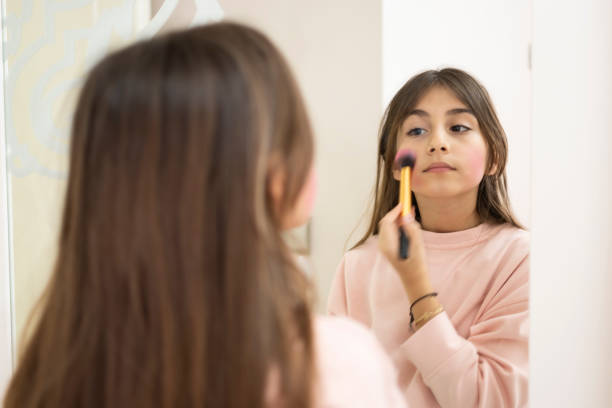 istock Cute girl fixing her make up, it is plastics 1308587794