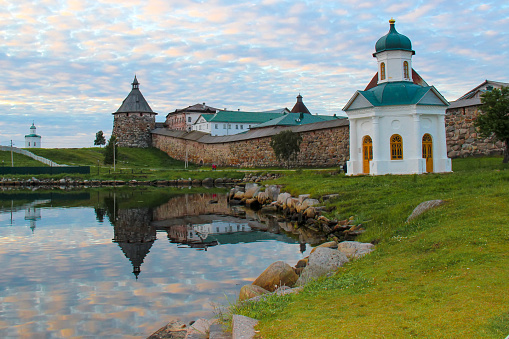 The old towers of the fortress are reflected in the lake. Reflection in the lake of the castle towers