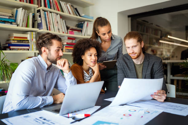 istock Group of business people collaborating on project in office 1308589654