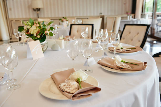 istock Table setting with sparkling wineglasses and cutlery on table, copy space. Menu mockup, place setting at wedding reception. Table served for wedding banquet in restaurant 1308590395