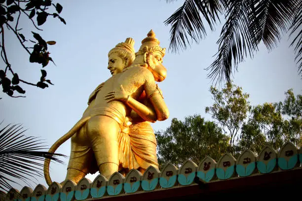 A beautiful horizontal portrait of the statue of Lord Hanuman and Lord Sriram hugging each other at Ramanjaneya Gudda Temple, Basavanagudi, Bangalore.