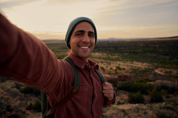 istock Young hiker on mountain during morning sunrise smiling and feeling fresh looking at camera 1308592620