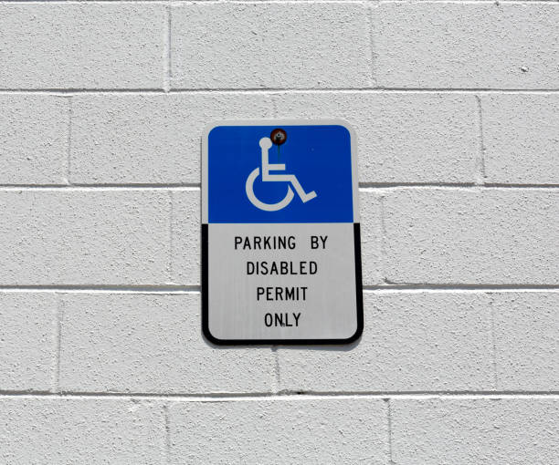 istock Disabled parking sign on a concrete block wall 1308593774