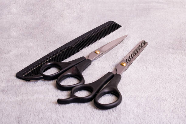 istock Barber scissors and comb on gray background 1308594092