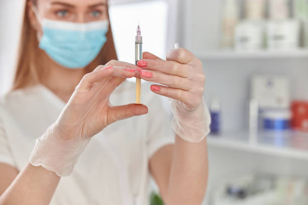 istock Confident caucasian beautiful doctor is preparing injection 1308594170