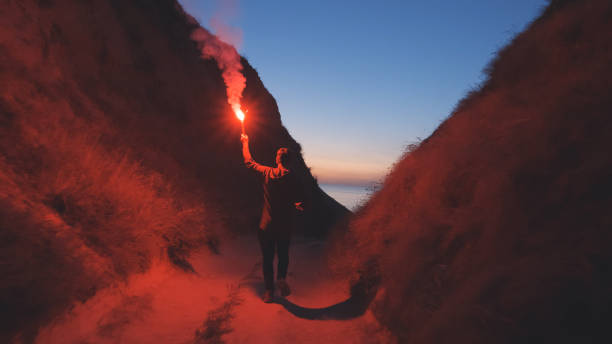 istock The man with a fire stick walking in the mountains 1308594367