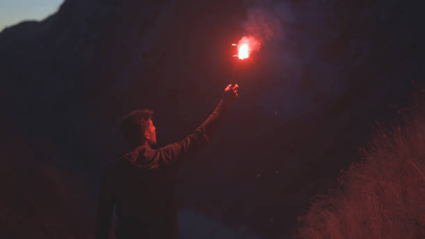 istock The man with a fire stick walking in the mountains 1308594519