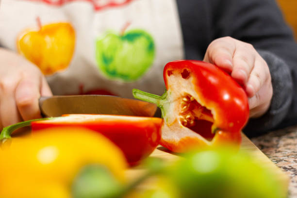 istock Girl cutting a pepper 1308594745