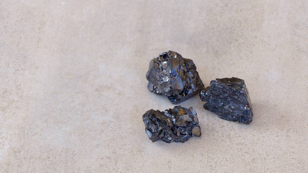 istock Three black shungite mineral stones on natural background 1308594748