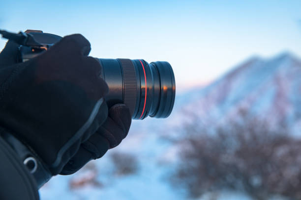 istock man holding camera in snowy nature 1308595434