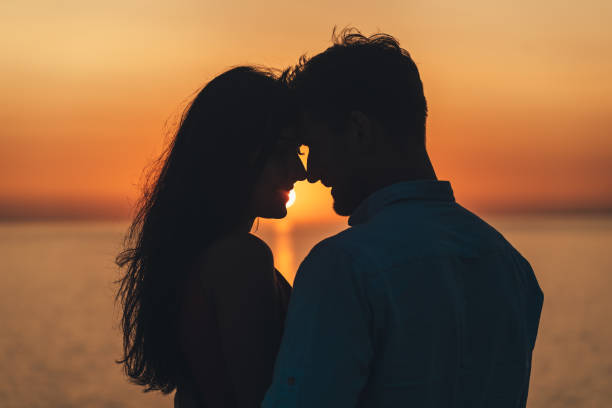 istock The two happy people standing on the beautiful sunset background 1308595662