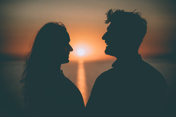 istock The two happy people standing on the beautiful sunset background 1308595729