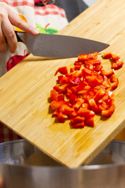 istock Girl pouring red pepper in a bowl 1308595826
