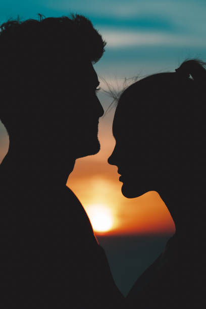 istock The romantic couple standing closely on the beautiful evening sky background 1308595842