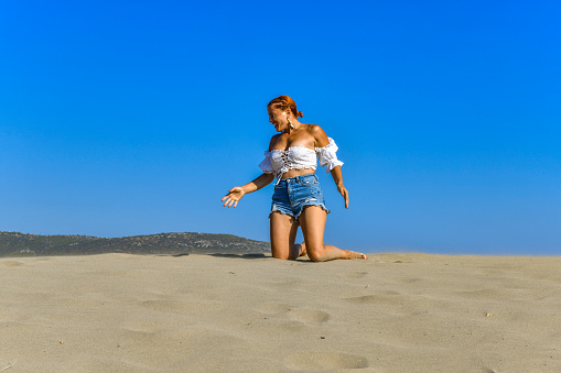 Young woman walking on the dunes. Patara Sand dunes, Turkey.