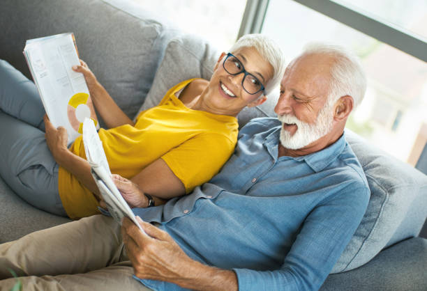 istock Mature couple reading magazines and having a conversation. 1308600207