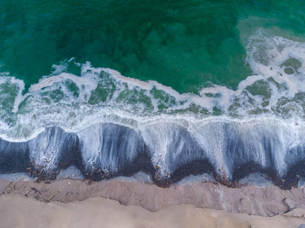 istock Aerial view of the waves when reaching the shore 1308600497