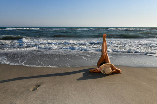istock Woman having fun on the beach. 1308601578