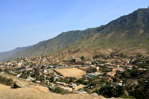 Nefasit, Ghinda Subregion, North Red Sea Region, Eritrea: town located in the Eritrean Highlands, built in a narrow valley and served by the the Italian colonial transportation infrastructures, the Asmara-Massawa road (P-1) and railway - in the image the Mosque, the P-1 road, the church, the soccer field...