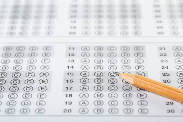 istock testing in exercise and exam paper. computer sheet with pencil in school test room, education concept 1308604601
