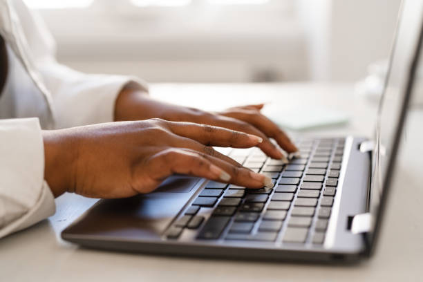 istock Woman typing on her laptop keyboard 1308604979