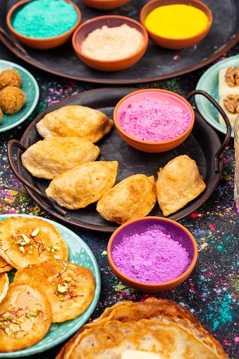 Traditional Indian festival food and gulal colors. Happy Holi concept.