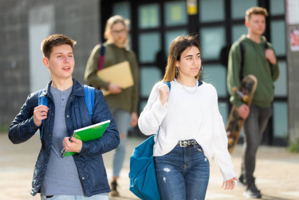 istock Two positive teens walk along street 1308607125
