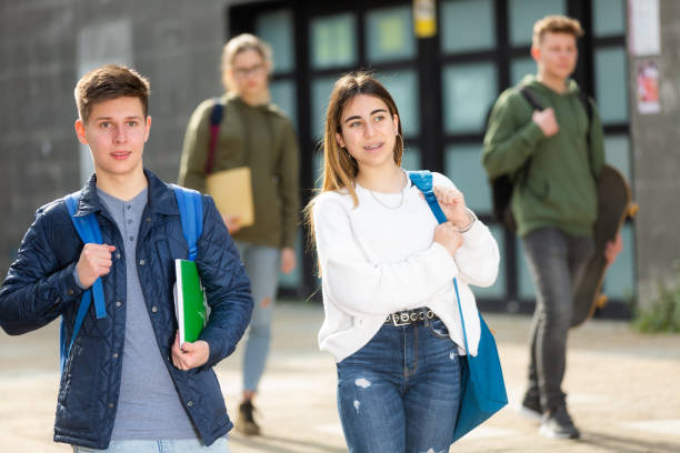 istock Smiling teenagers walking outside after lessons 1308607199