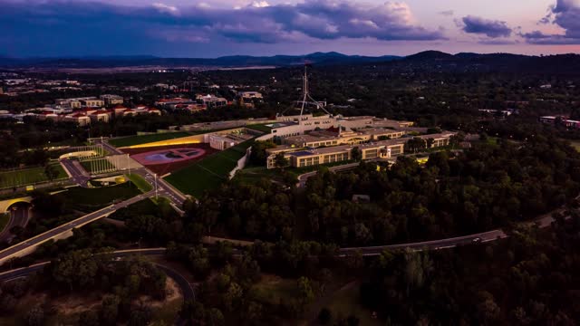 Aerial hyperlapse of the Australian Parliament House at evening twilight