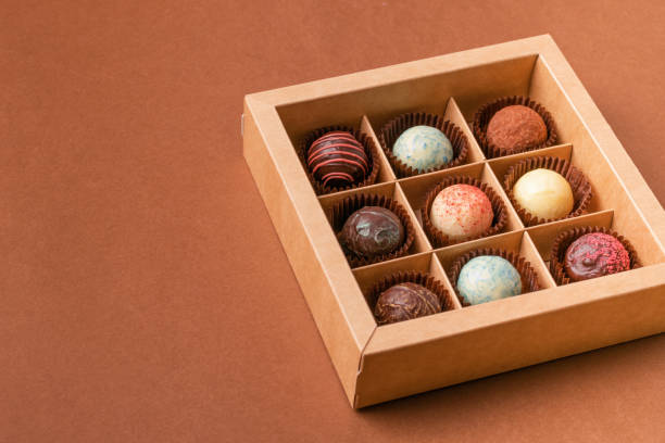 istock Chocolate candies truffle from various chocolate in a box satin ribbon 1308607491