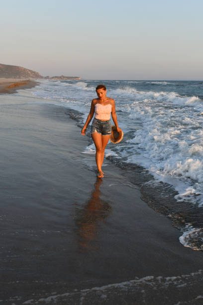 istock Woman having fun on the beach. 1308610628