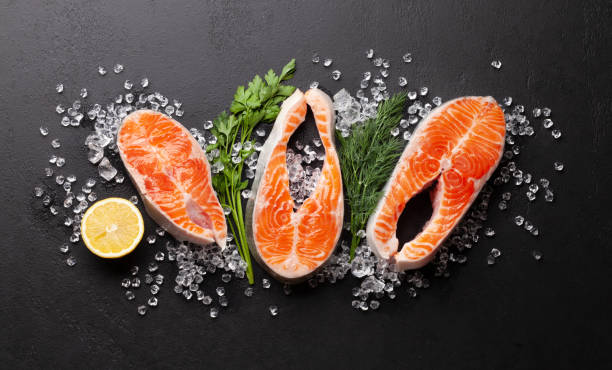 istock Fresh raw salmon cooking. Fish steaks with herbs and spices 1308611884