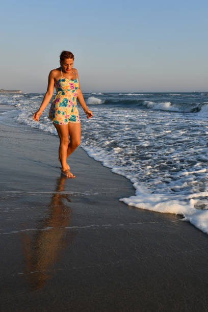 istock Woman having fun on the beach. 1308612585