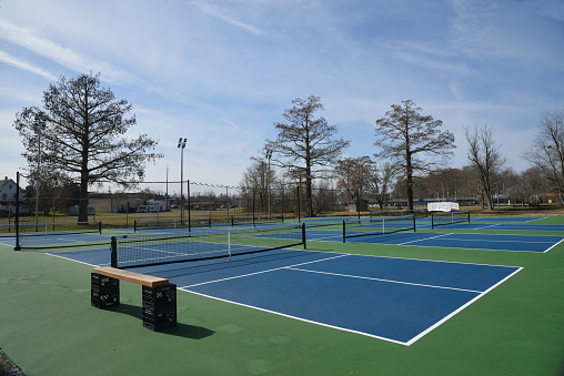Tennis courts in a city park waiting for warmer weather and leaves on the trees in Pocomoke City, Maryland\n\nPLEASE NOTE: THIS IS A PUBLIC PARK