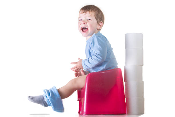Happy baby boy sitting on chamber pot Happy baby boy sitting on chamber pot. Potty training concept accustom stock pictures, royalty-free photos & images