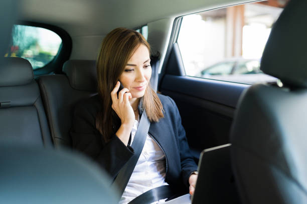istock Professional pretty woman mutlitasking during a car ride 1308613314